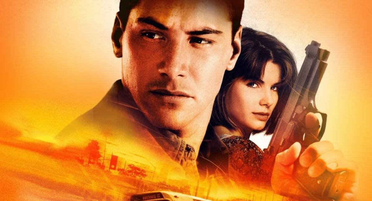 Imagem do filme Velocidade Máxima 1994 com dois atores com armas e chamas de fogos